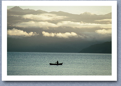 Fisherman rowing out onto lake, Rinihue