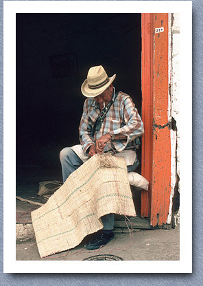 Man stitching horse's saddle blanket