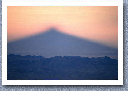 Early morning shadow of Cayambe across paramo