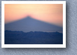 Early morning shadow of Cayambe across paramo